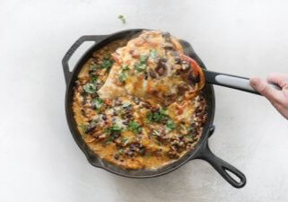 Chicken Fajita Casserole -- easy weeknight recipe with fajita veggies, black beans, sour cream and cheese on chicken breasts & baked in a cast iron skillet.